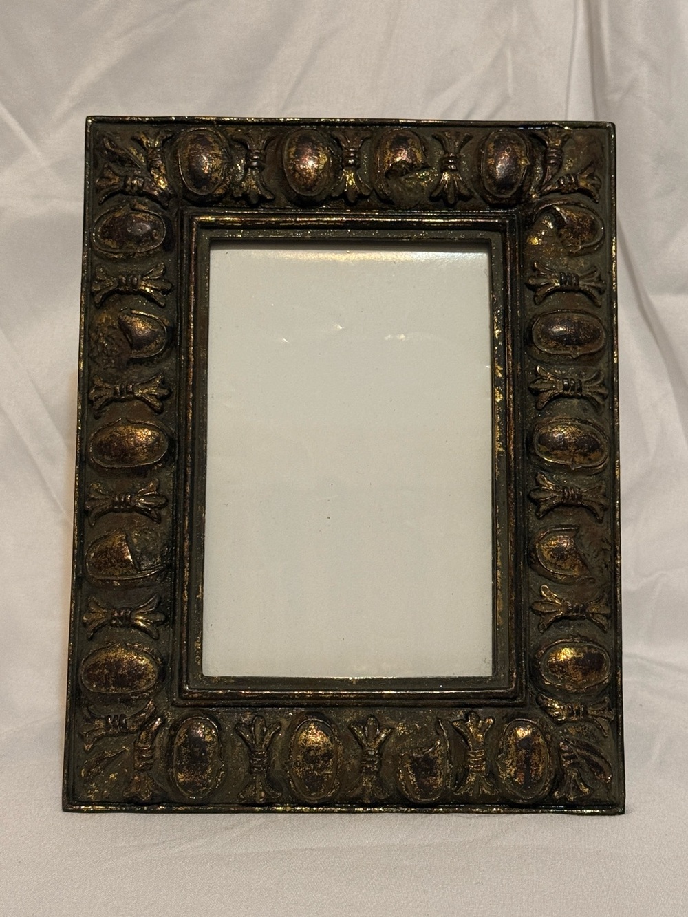 An ornate, antique style tabletop picture frame